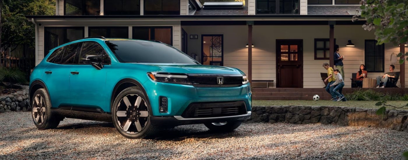 A blue 2026 Honda Prologue parked in a driveway.