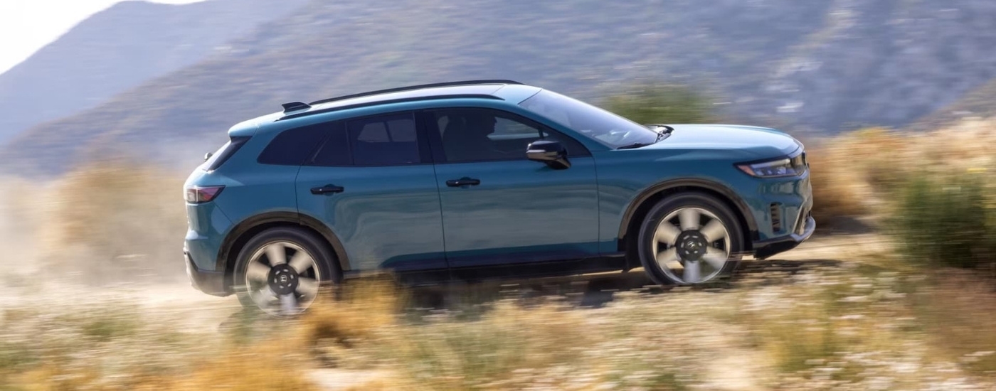 A blue 2024 Honda Prologue Elite driving.