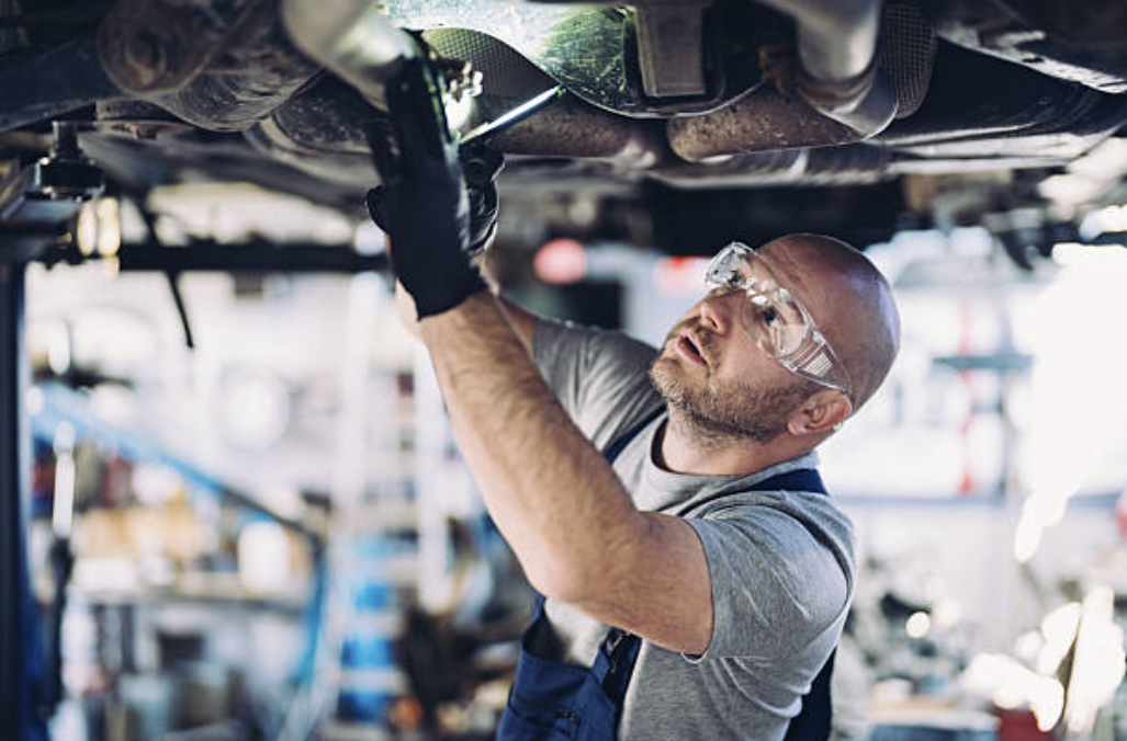 Mechanic working on vehicle engine