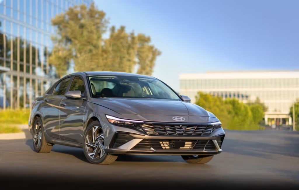 a sleek new 2025 Hyundai Elantra parked in front of glass building