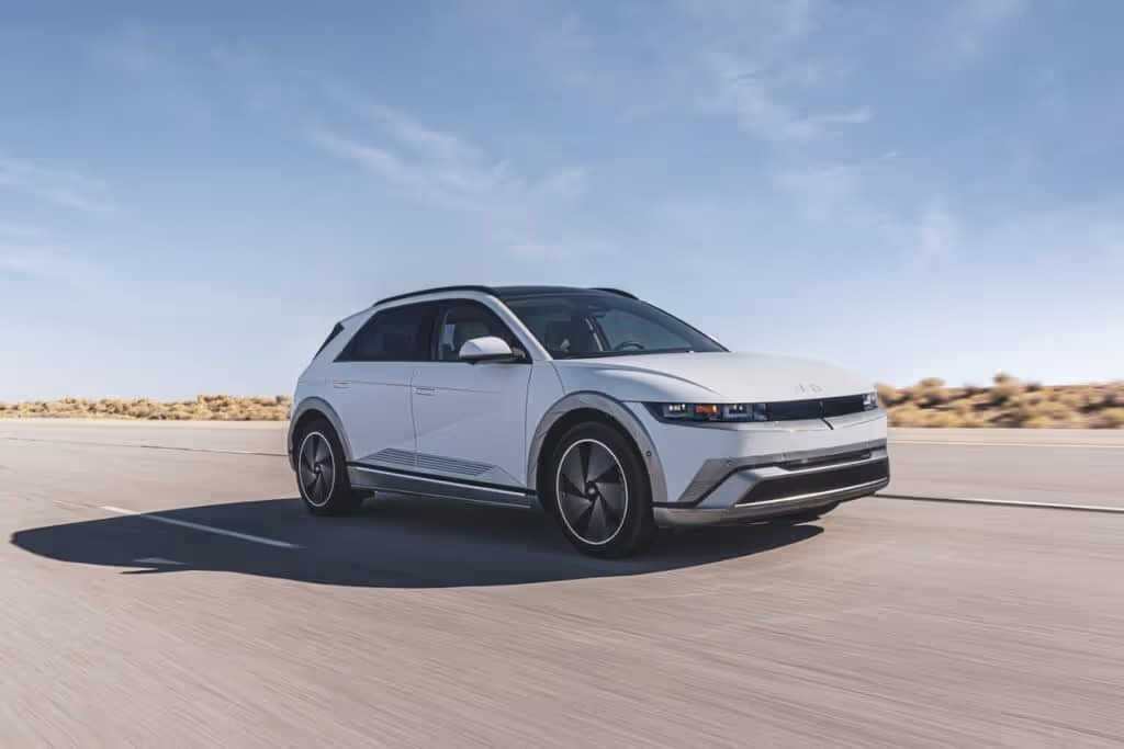 A 2025 Hyudai IONIQ 5 SUV driving along a scenic road, showcasing its sleek design and electric capabilities.