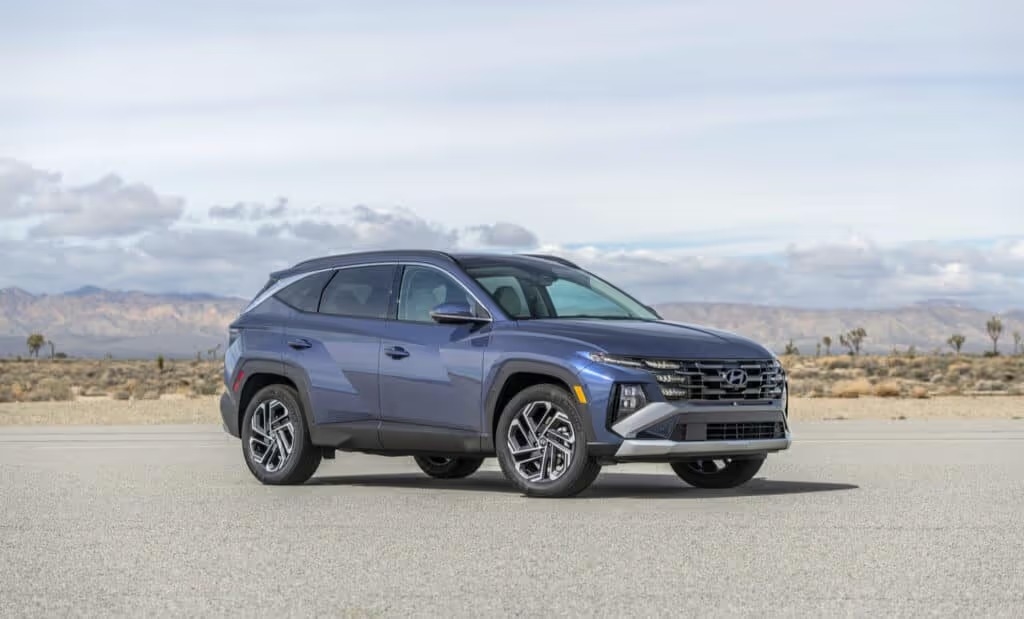 A blue 2025 Hyundai Tucson parked under a vast blue sky