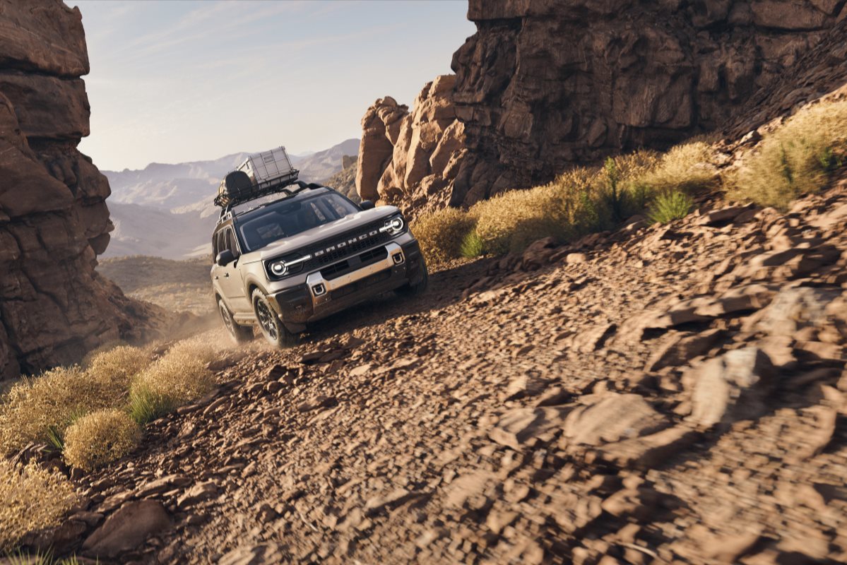 Ford Bronco Sport driving on a rocky off-road trail, demonstrating its performance, all-wheel-drive capability, and adventure-ready design.