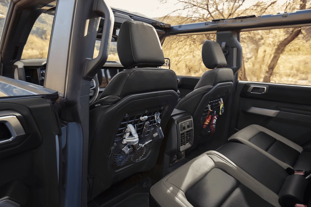 Interior of a Ford Bronco featuring spacious rear seating, durable materials, and convenient seatback storage for everyday adventures.