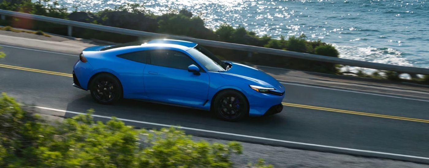Blue 2026 Honda Prelude driving on a highway