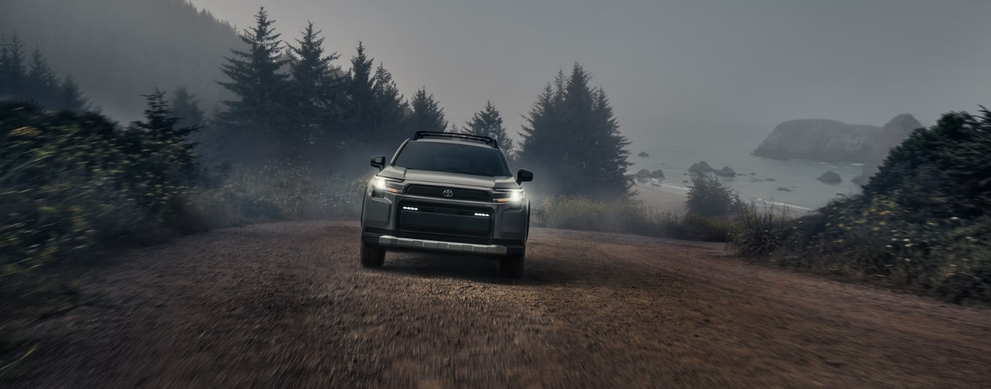Grey 2026 Toyota RAV4 Woodland driving on a trail