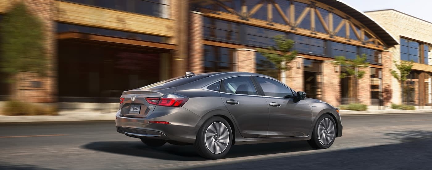 Grey 2021 Honda Insight Touring from the side while driving down the street.