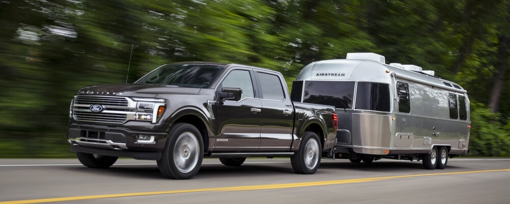 2024 Ford F-150 towing a trailer in the woods