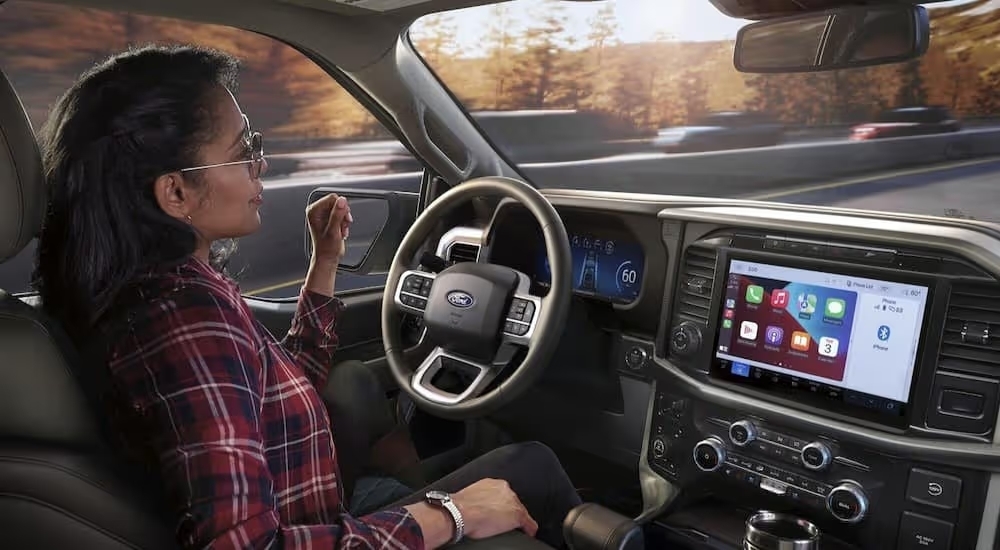 The gray interior and dash of a 2024 Ford F-150 Lariat is shown.