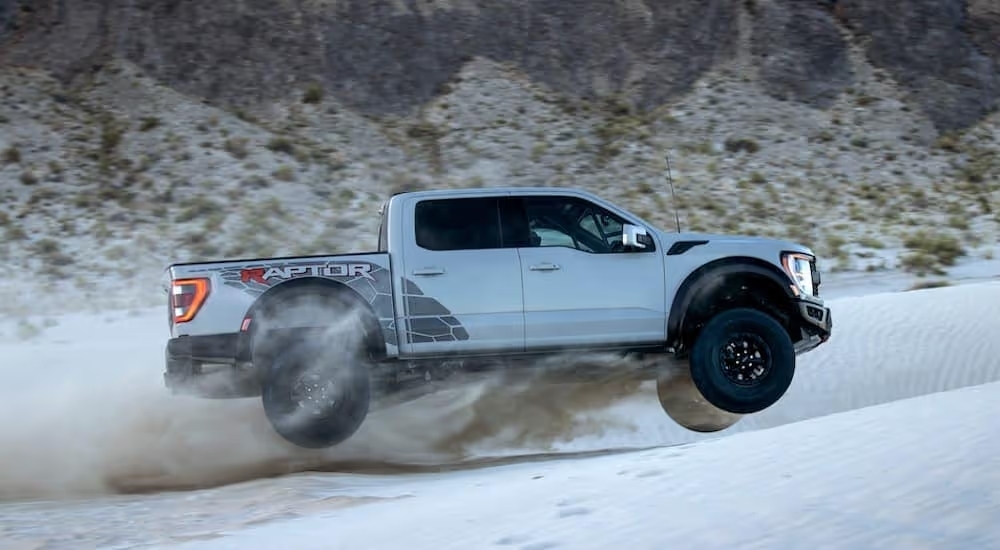 A silver 2023 Ford F-150 R is shown from the side while off-road.