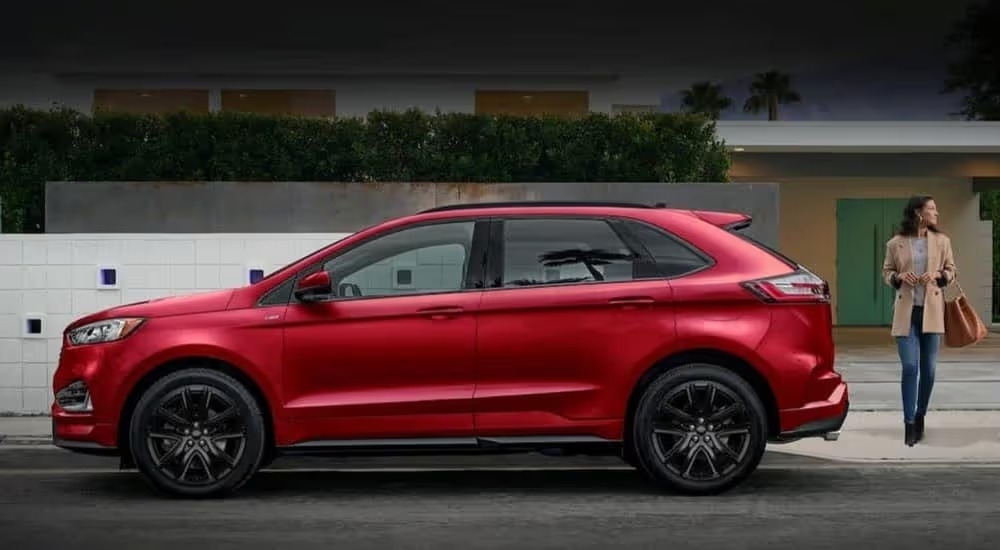 A red 2024 Ford Edge for sale is shown parked near a person.