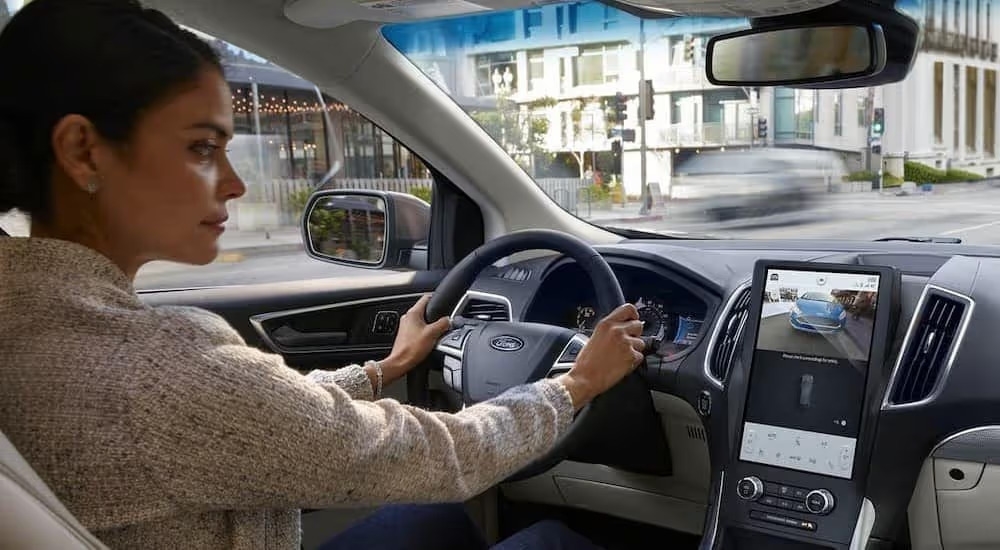 The black and white interior and dash of a 2024 Ford Edge is shown.