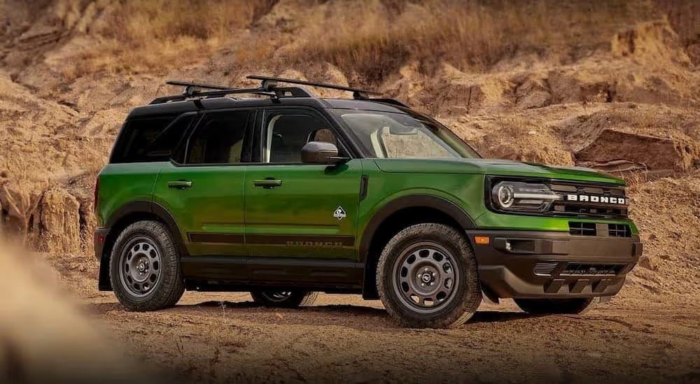 A popular Ford Bronco Sport for sale, a green 2023 Ford Bronco Sport Outer Banks, is shown parked off-road.