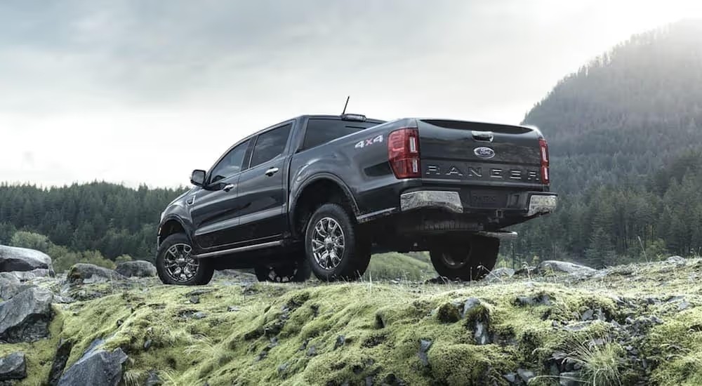 View from below of a black 2021 Ford Ranger parked in the mountains.