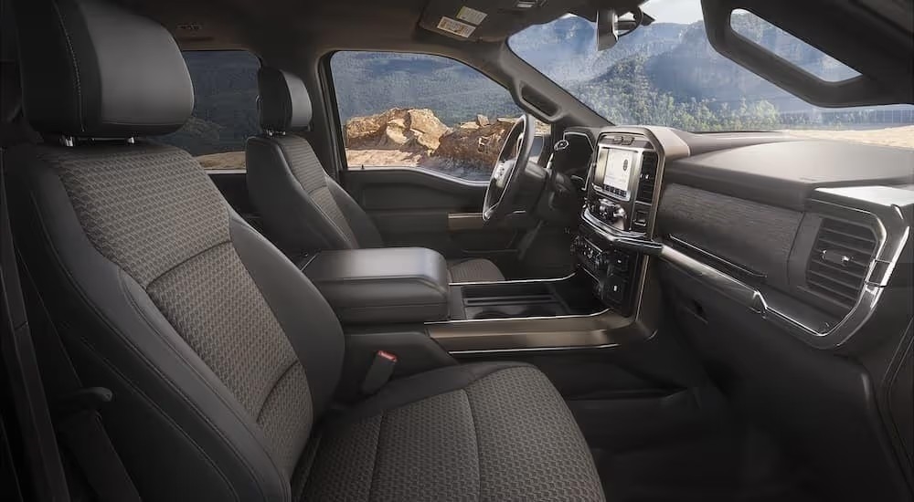 The black interior of a 2023 Ford F-150 Rattler shows the front seats.