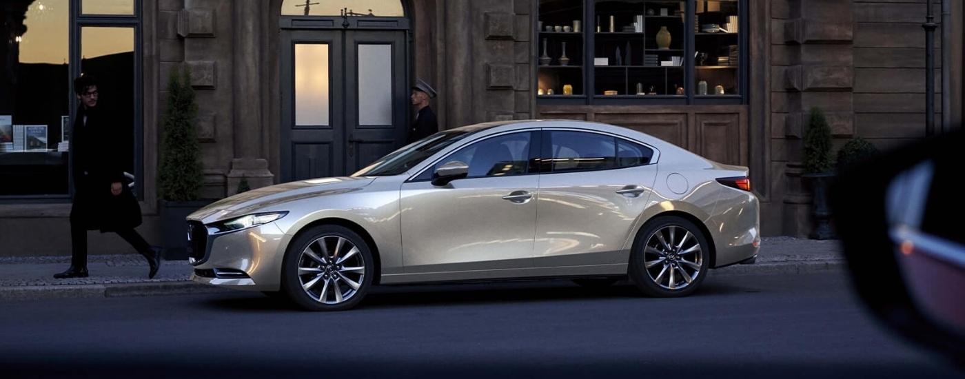 Tan 2026 Mazda3 parked on a city street