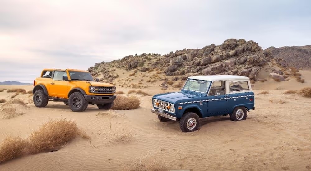 An orange and a blue Ford Bronco are shown after leaving a Tennessee Ford Bronco dealer.
