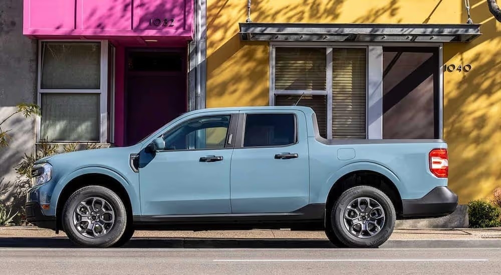 A light blue 2022 Ford Maverick is shown from the side parked on a city street after leaving a Tullahoma Ford dealership.