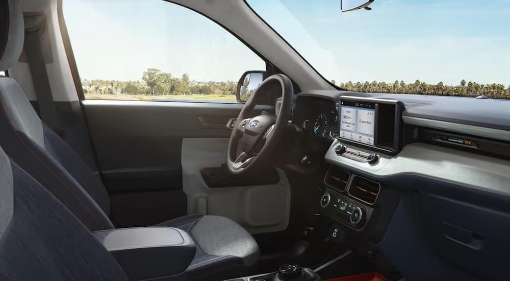 The grey interior of a 2022 Ford Maverick shows the steering wheel.