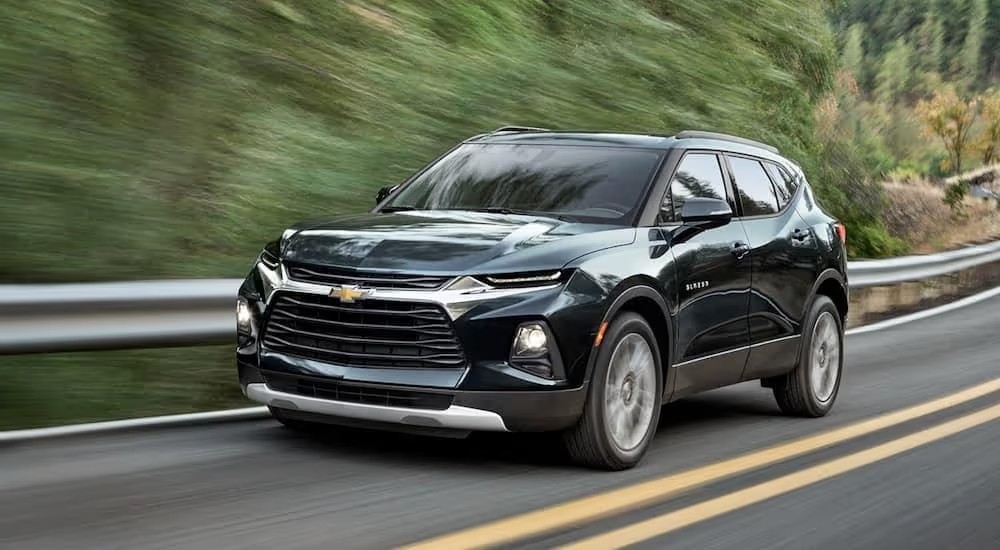 A black 2020 Chevy Blazer is shown from a side angled driving down an open road after looking at a used car dealer in Shelbyville.