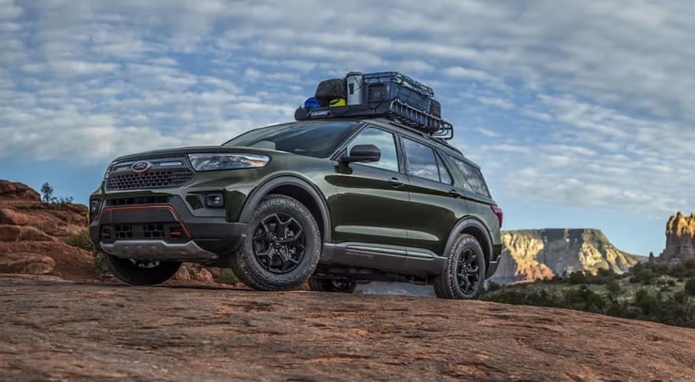 A dark green 2021 Ford Explorer Hybrid is parked in the desert.