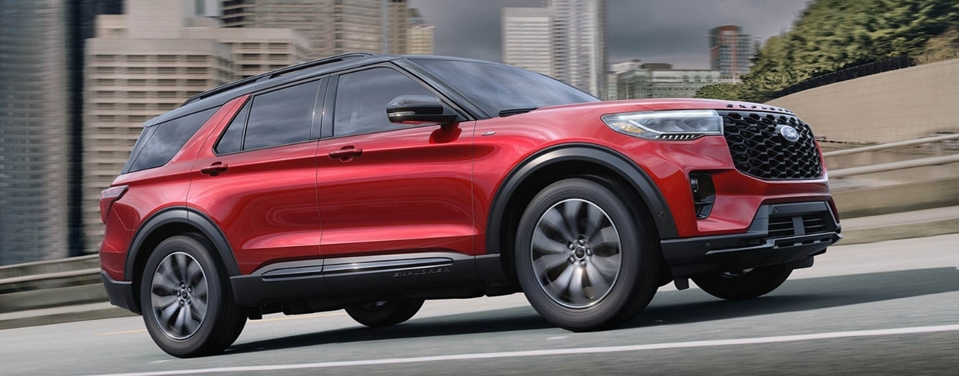 A red 2026 Ford Explorer ST-Line driving on a highway