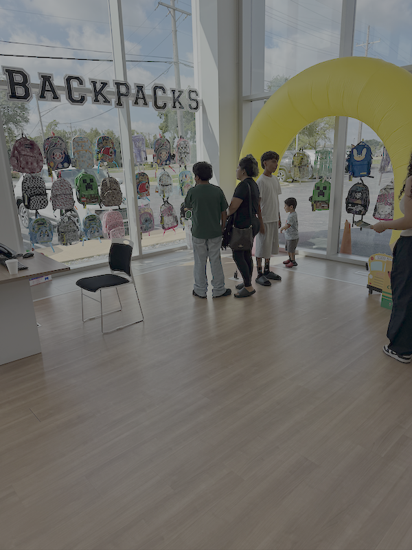 Backpacks displayed for local students during the Castle Cares Back to School Pit Stop in Downers Grove