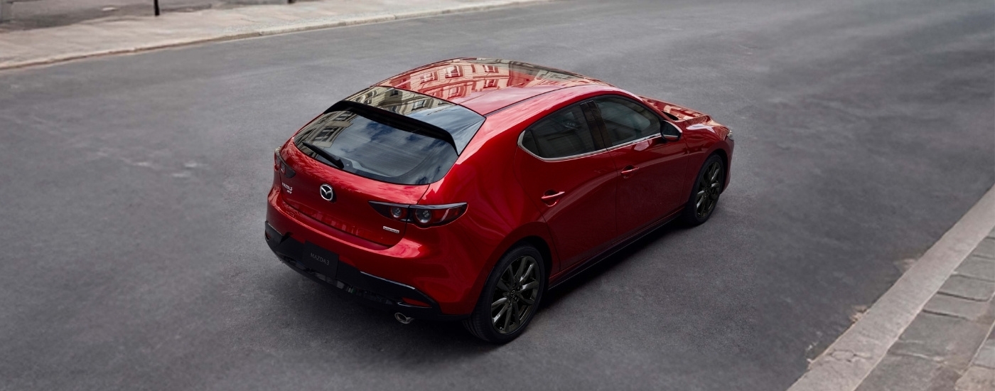 Red 2023 Mazda3 parked on pavement