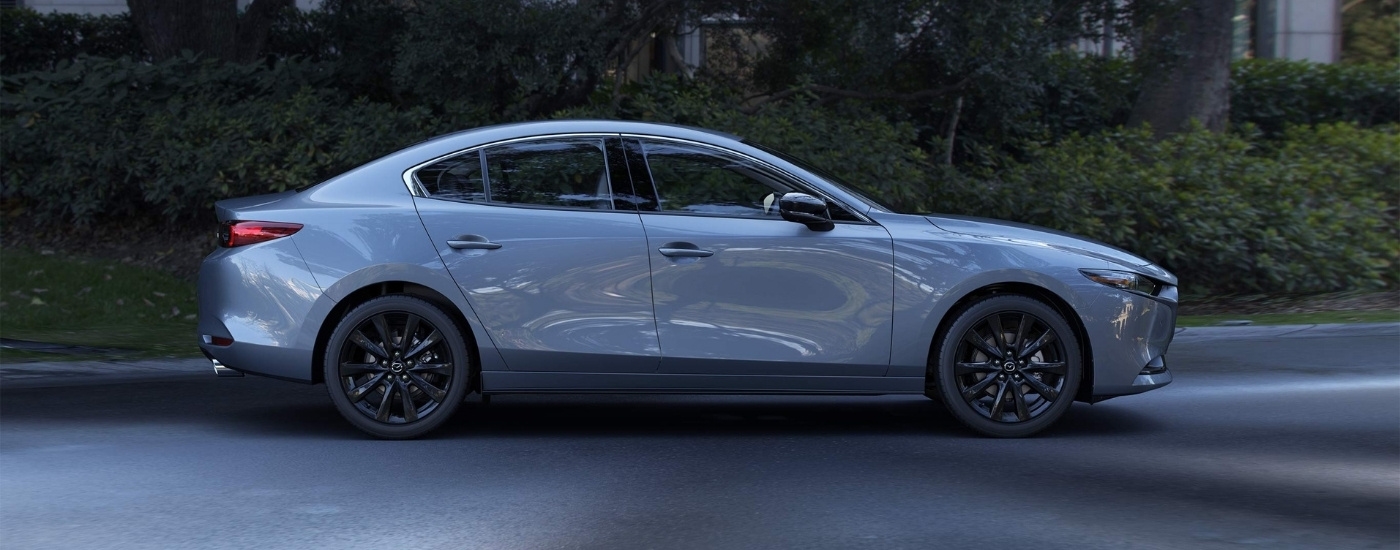 Grey 2026 Mazda3 near bushes