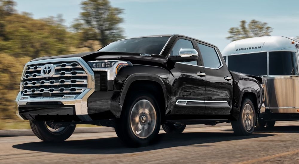 A black 2026 Toyota Tundra Hybrid CrewMax towing an airstream.