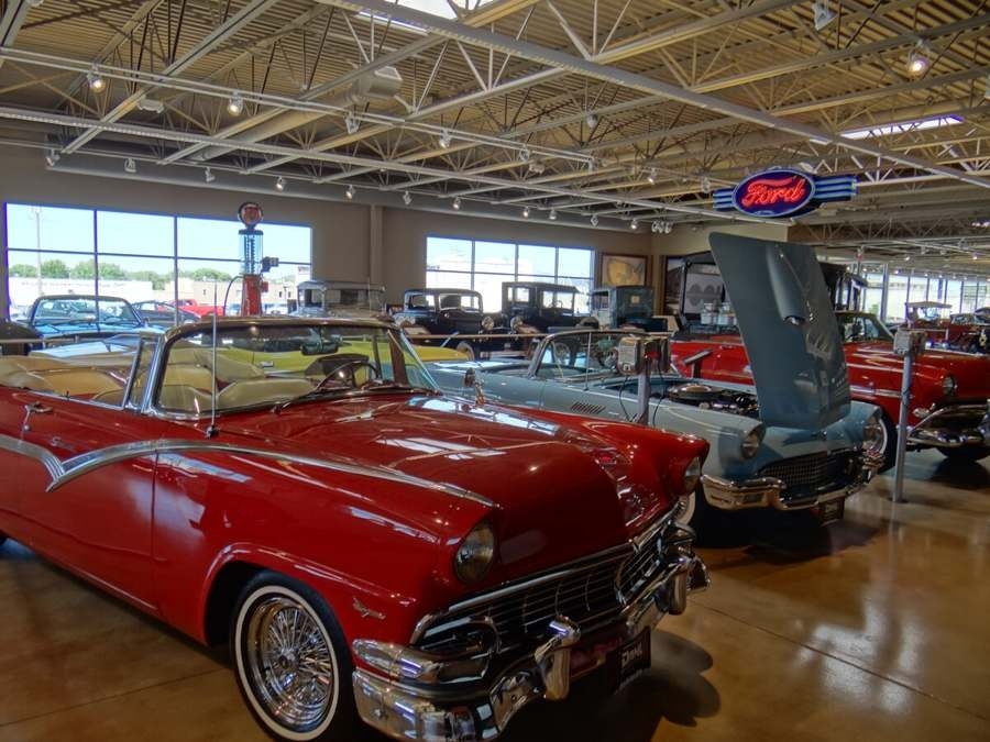 Interior of an auto museum with rows of restored classic cars