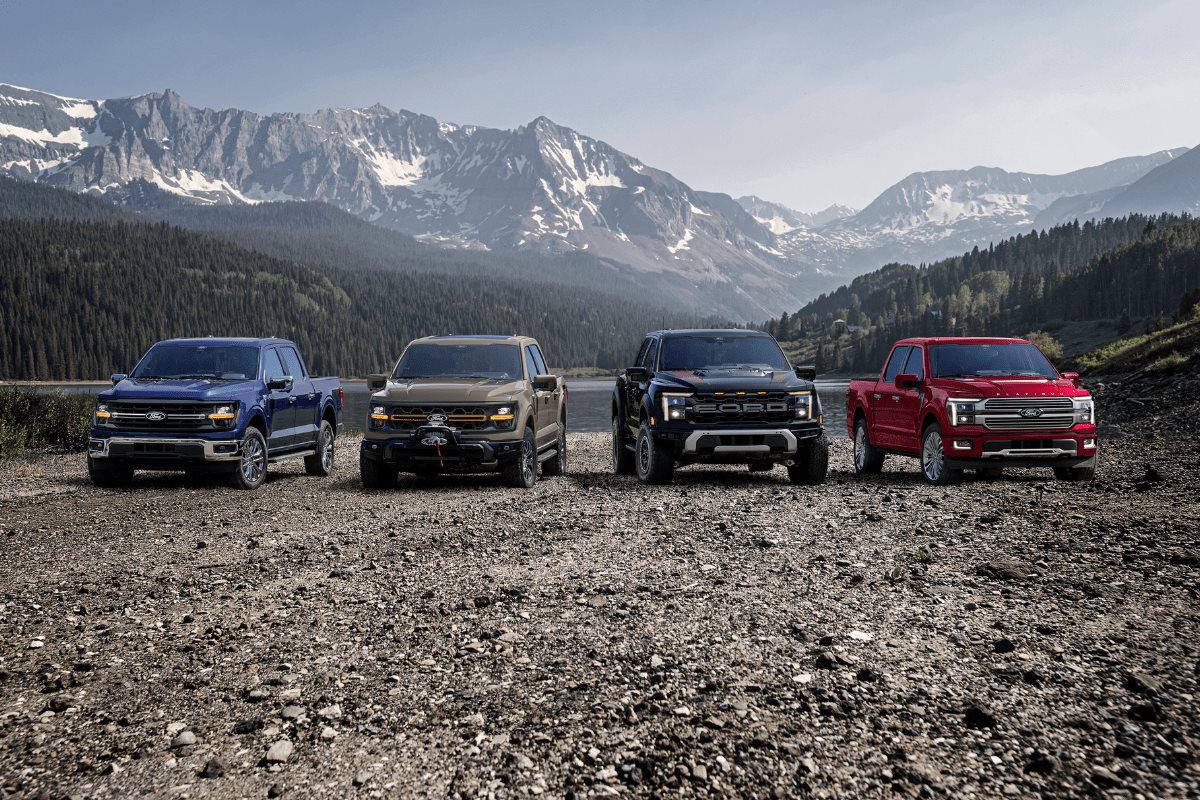 2026 Ford truck lineup featuring four Ford trucks in a mountain setting