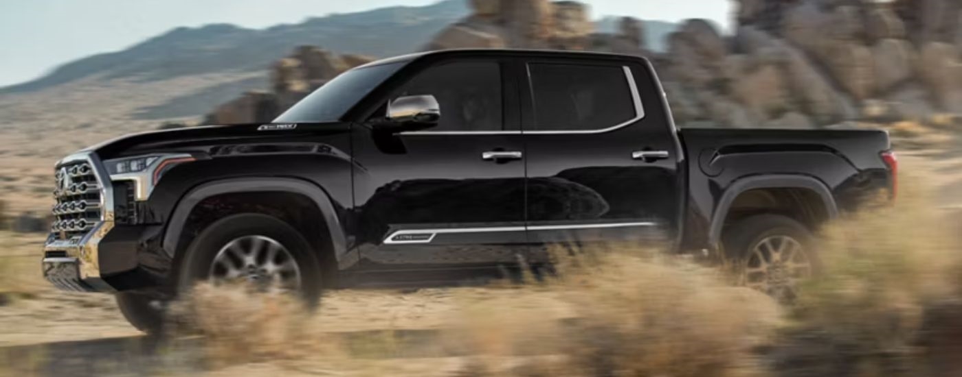 Black 2026 Toyota Tundra 1974 Edition driving off-road.