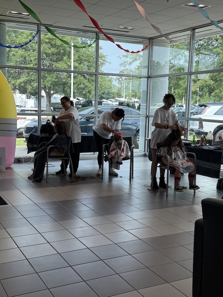 Free haircuts in progress during the Castle McHenry Cars and Cuts event