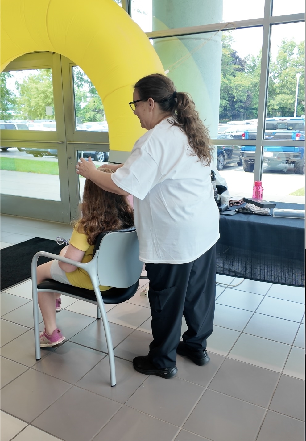 Student receiving a free haircut at the Cars and Cuts back-to-school event