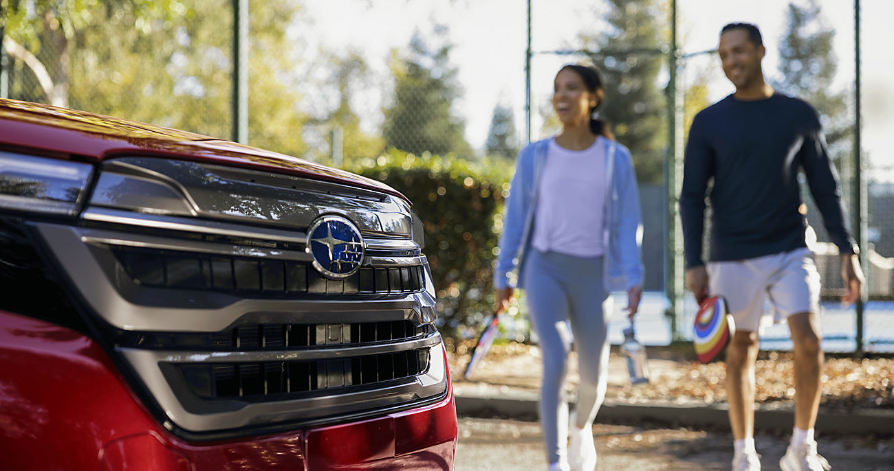Couple walking toward one of the best Subaru SUVs