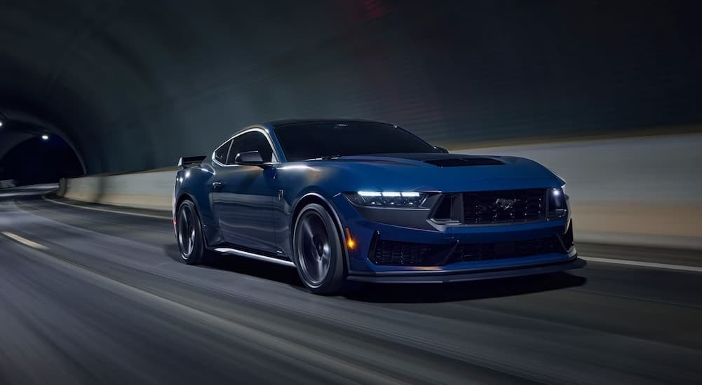 A blue 2026 Ford Mustang Dark Horse driving in a tunnel.