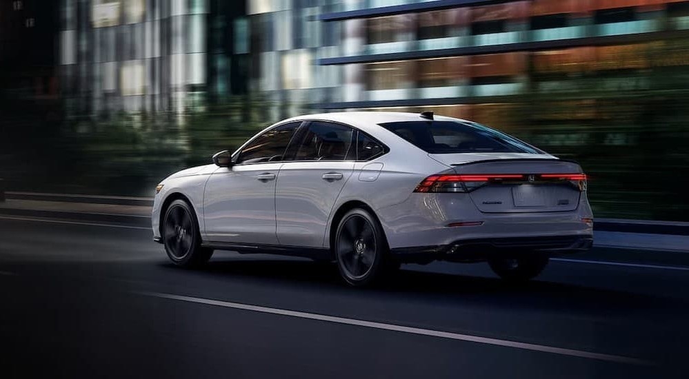 A white 2026 Honda Accord driving in a city.
