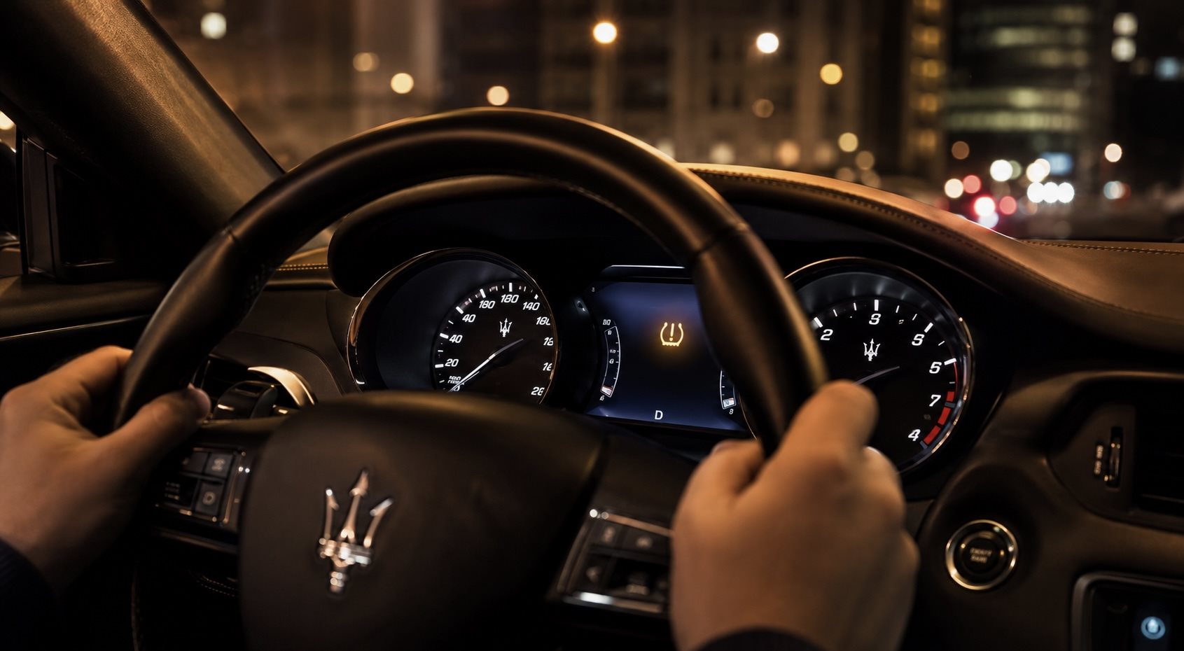 Maserati instrument cluster with an amber warning symbol illuminated