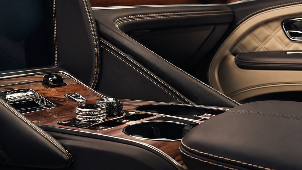 Bentley Bentayga interior showing hand-finished leather, wood veneer and metal detailing