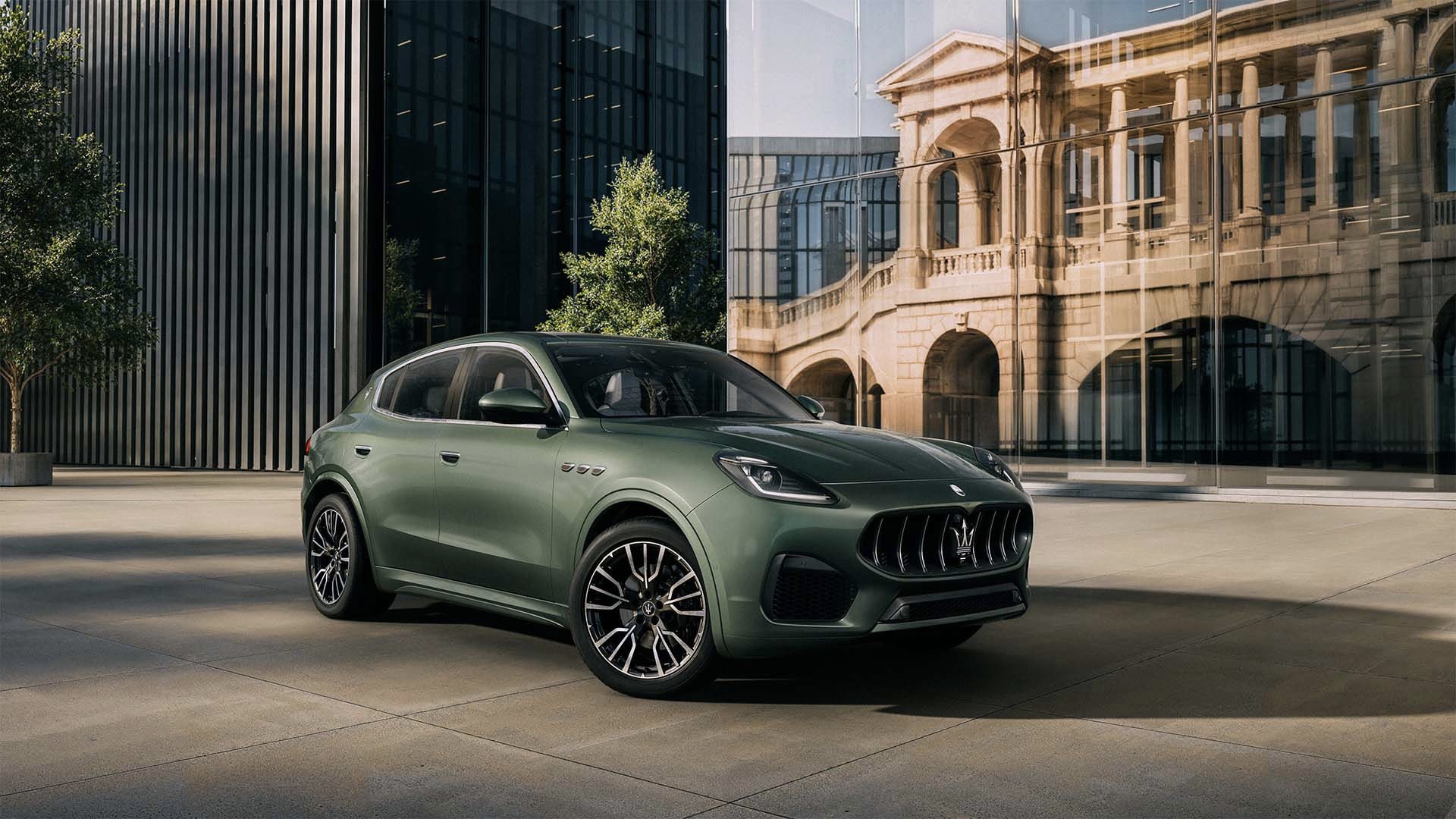 Maserati parked outside a modern dealership in warm afternoon light