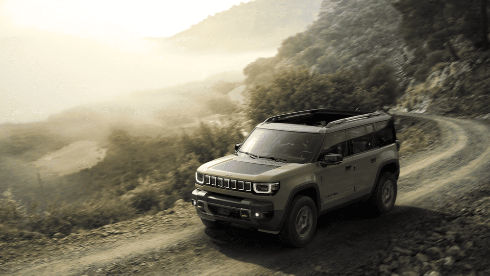 2026 Jeep Recon in tan navigating a misty mountain trail for electric adventure in Margate FL