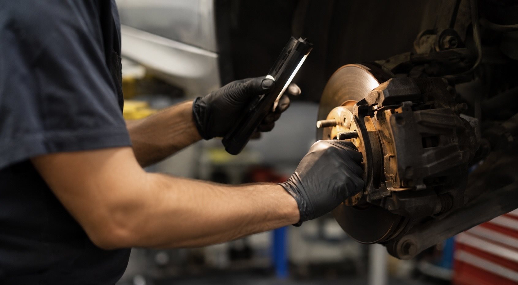 Mazda-certified technician performing a multi-point inspection at Brickell Mazda