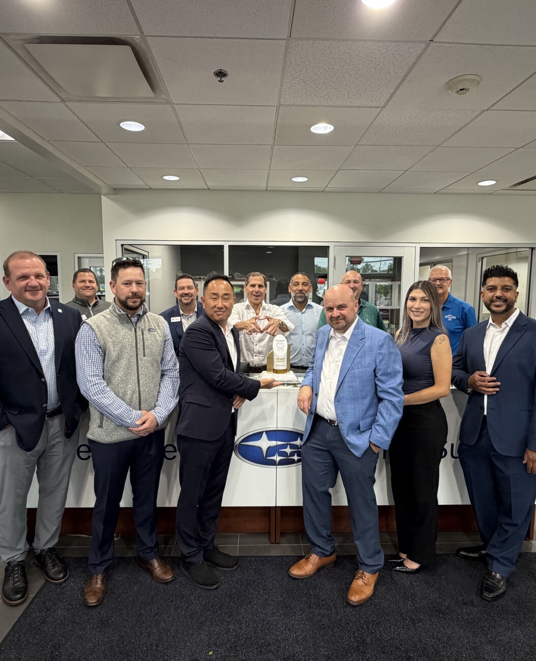 2026 Subaru Love Promise Heart Award presented to Muller Subaru, displayed on a counter.