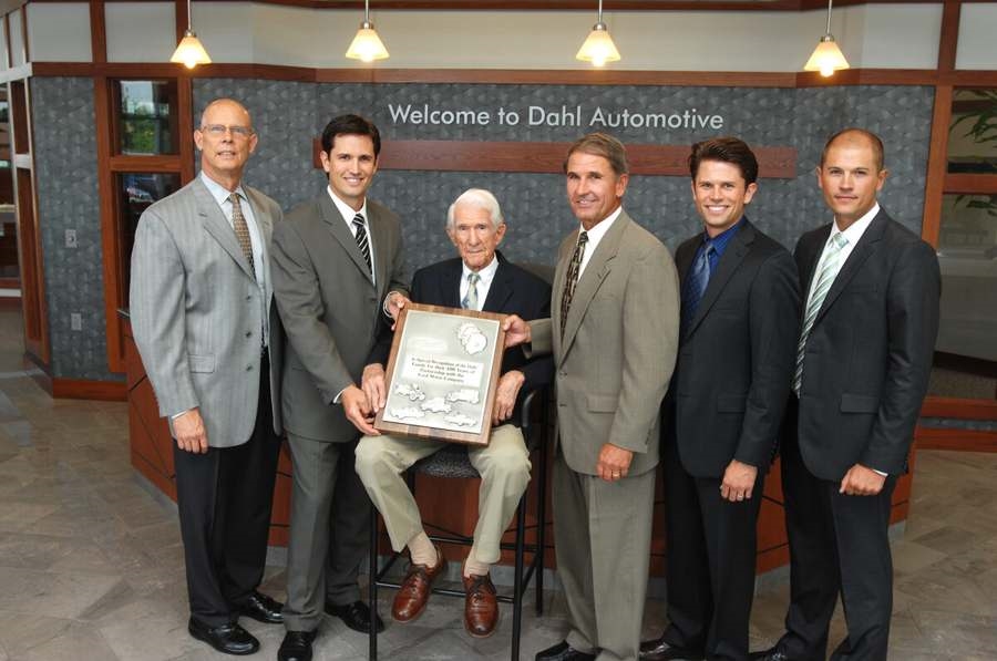 Group photo at Dahl Automotive with Ford executive Ken Czubay and three generations of the Dahl family