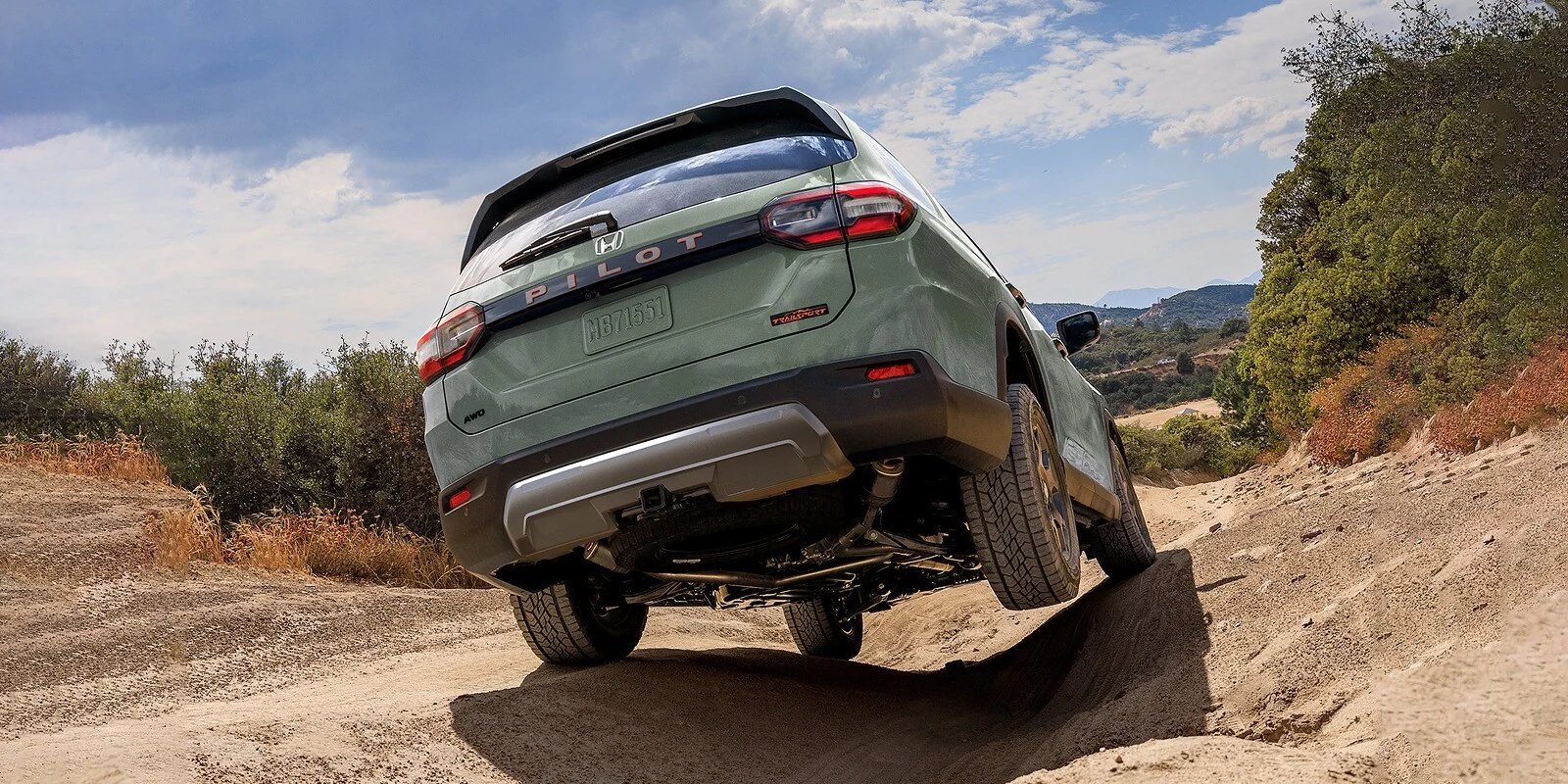2026 Honda Pilot TrailSport in Ash Green Metallic on a dirt trail