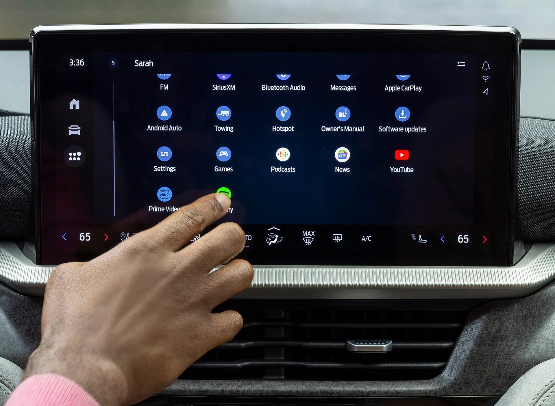 A driver using the 13.2-inch centre touchscreen in a 2026 Ford Explorer