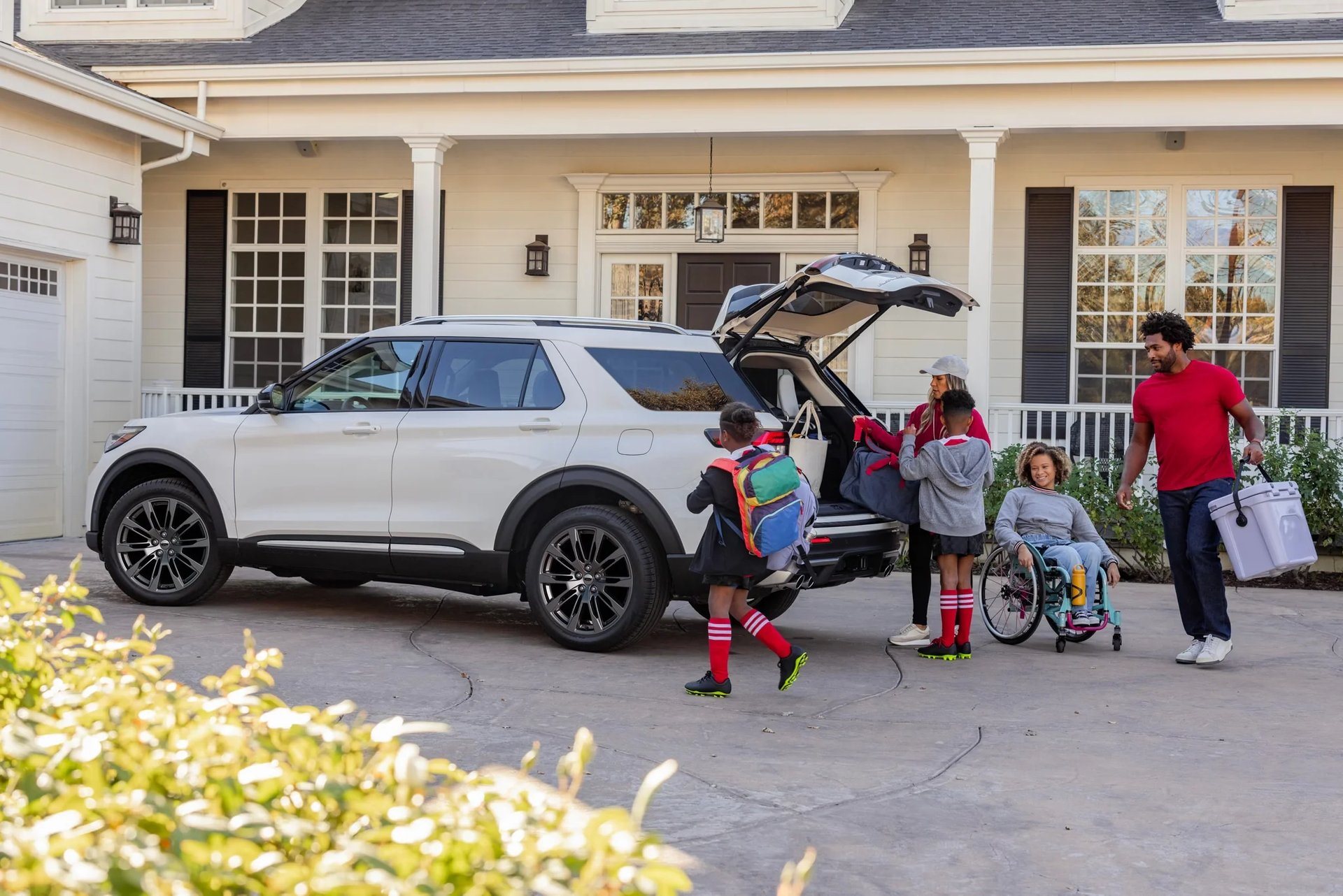 A family loading gear into a Ford Explorer in the driveway, the kind of move Oak Grove KY households make on orders