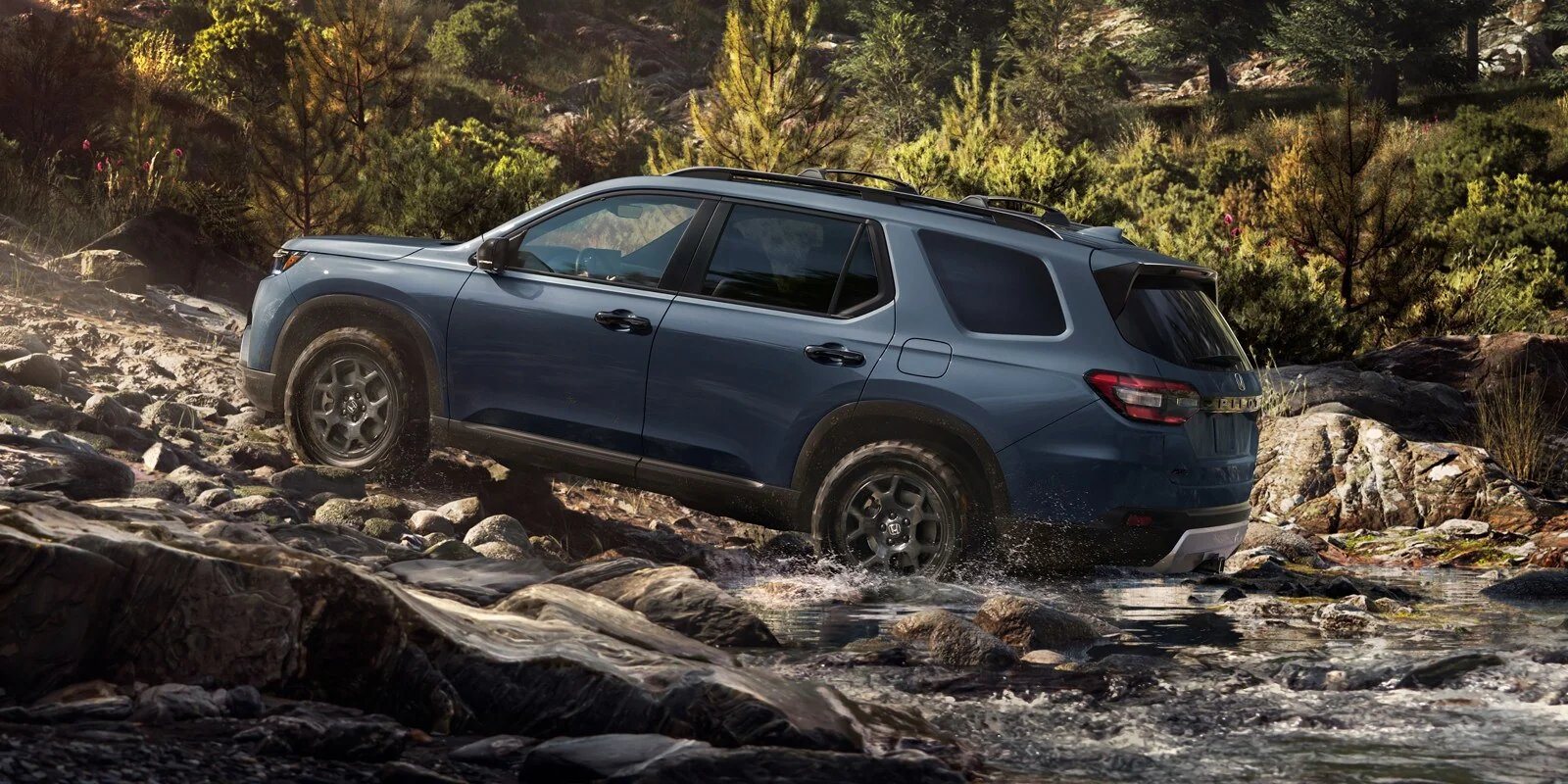 2026 Honda Pilot TrailSport crossing a rocky creek, the kind of surface found on Land Between the Lakes access roads