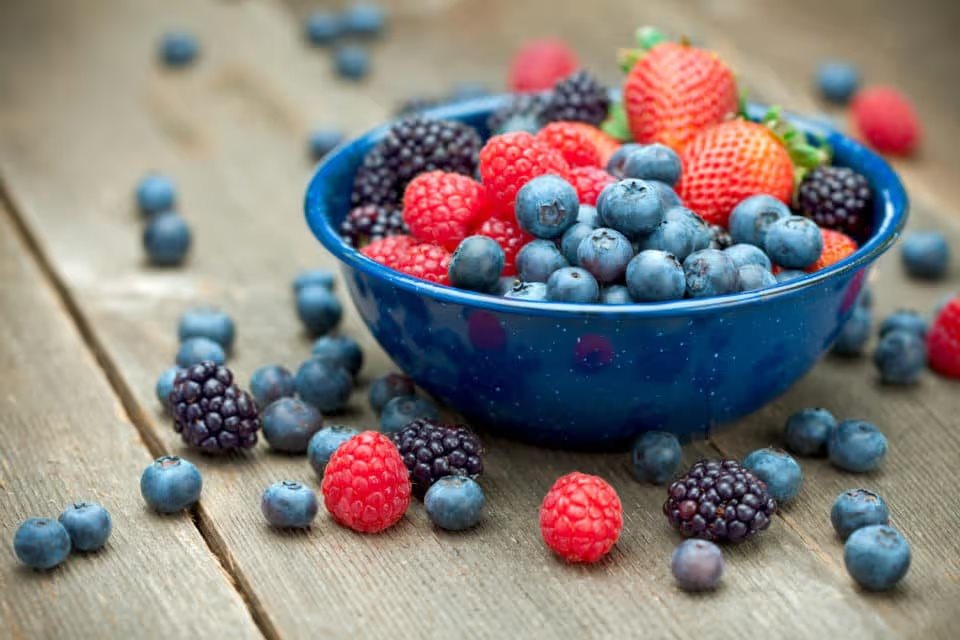 A bowlful of delicious organic berries. Strawberries, blackberries, blueberries and raspberries.